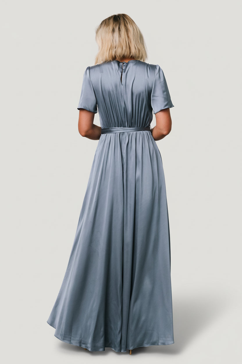 Fabric detail shot of whisper blue satin texture and subtle sheen, illustrating smooth finish and slight stretch suitable for occasion wear.