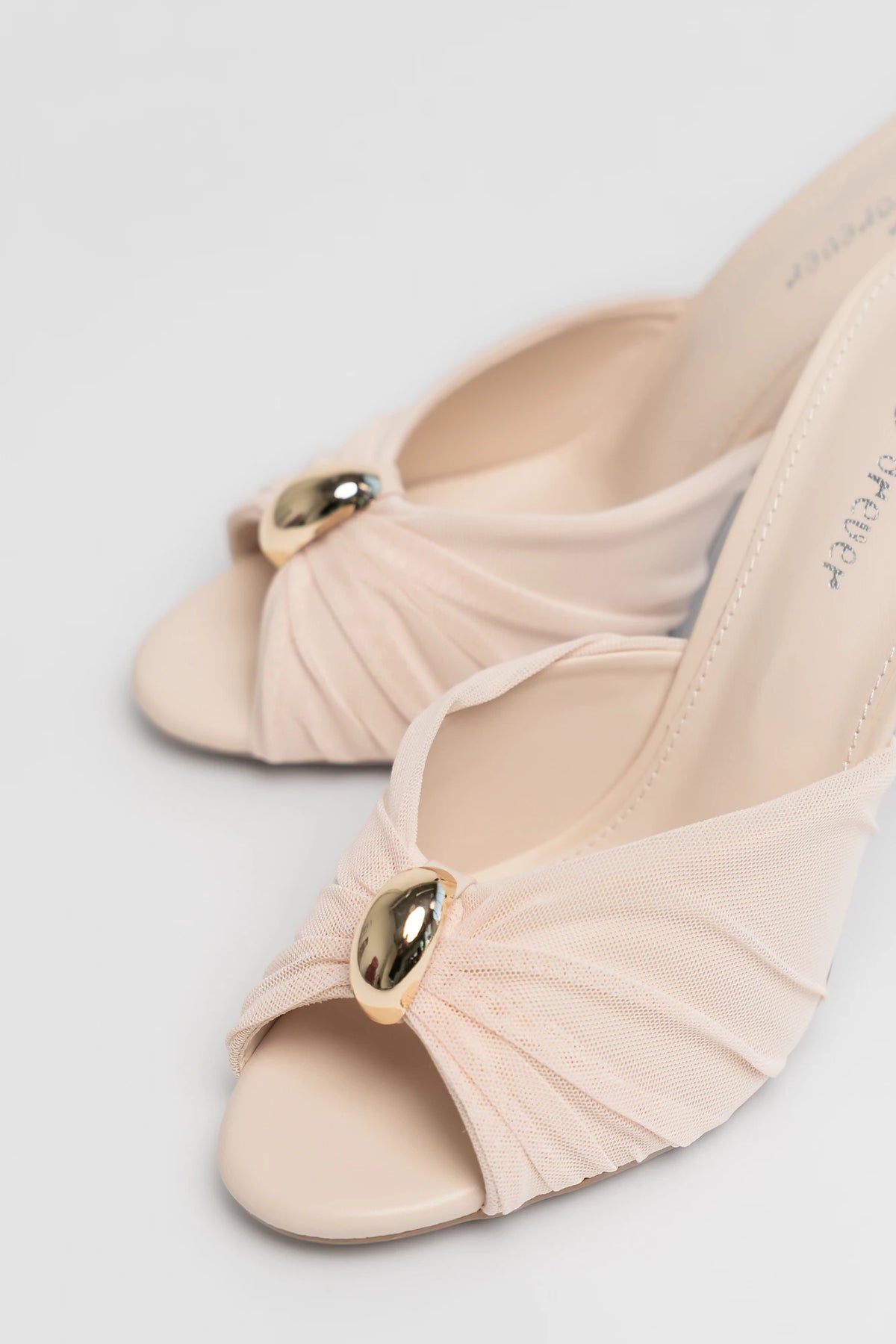 Aiko Slim Stiletto Heel in Natural with pleated fan-style upper, gold-tone accent, open toe, and slim stiletto heel.