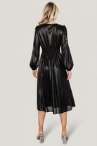 Aisha Shimmer Midi Dress in black styled with minimal accessories; shows skirt movement and full lining of bodice and skirt.