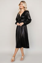 Back view of Aisha Shimmer Midi Dress revealing smocked waistband and gathered skirt for a comfortable, flattering fit.