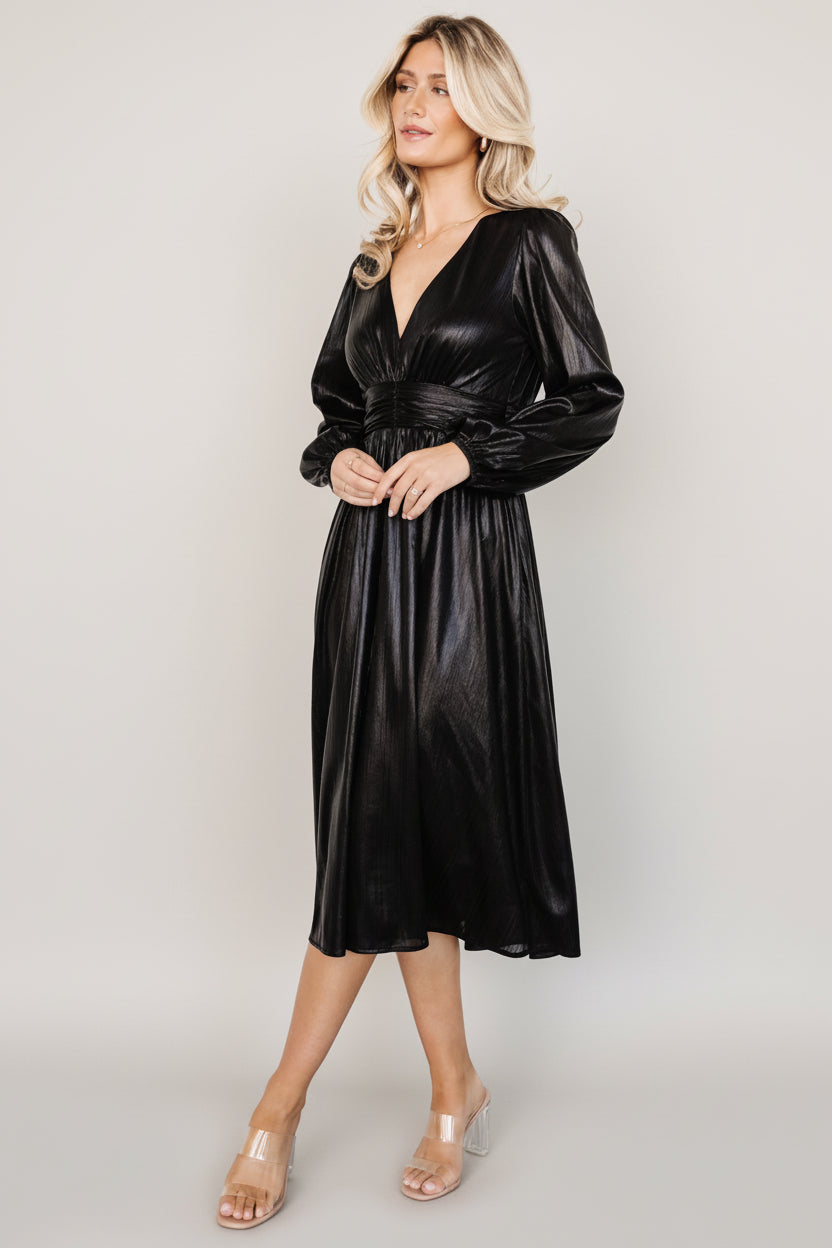 Back view of Aisha Shimmer Midi Dress revealing smocked waistband and gathered skirt for a comfortable, flattering fit.