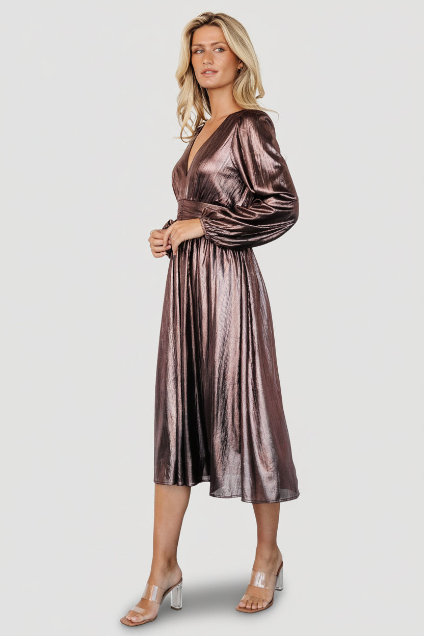 Front view of bronze Aisha shimmer midi dress on model showing deep V-neck, smocked waist, and gathered flowing skirt.