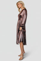 Detail of puffed sleeve with elastic cuff on the bronze shimmer dress, showing unlined sleeve texture and finish.