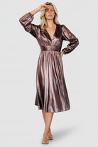 Close-up of the bodice showing the deep V-neckline and gathered waist detail in bronze shimmering stretch fabric.
