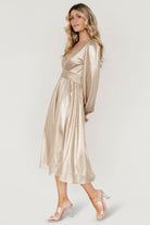 Close-up of Aisha dress bodice in champagne, showing deep V-neckline, gathered bodice, smocked back and subtle metallic sheen of fabric.