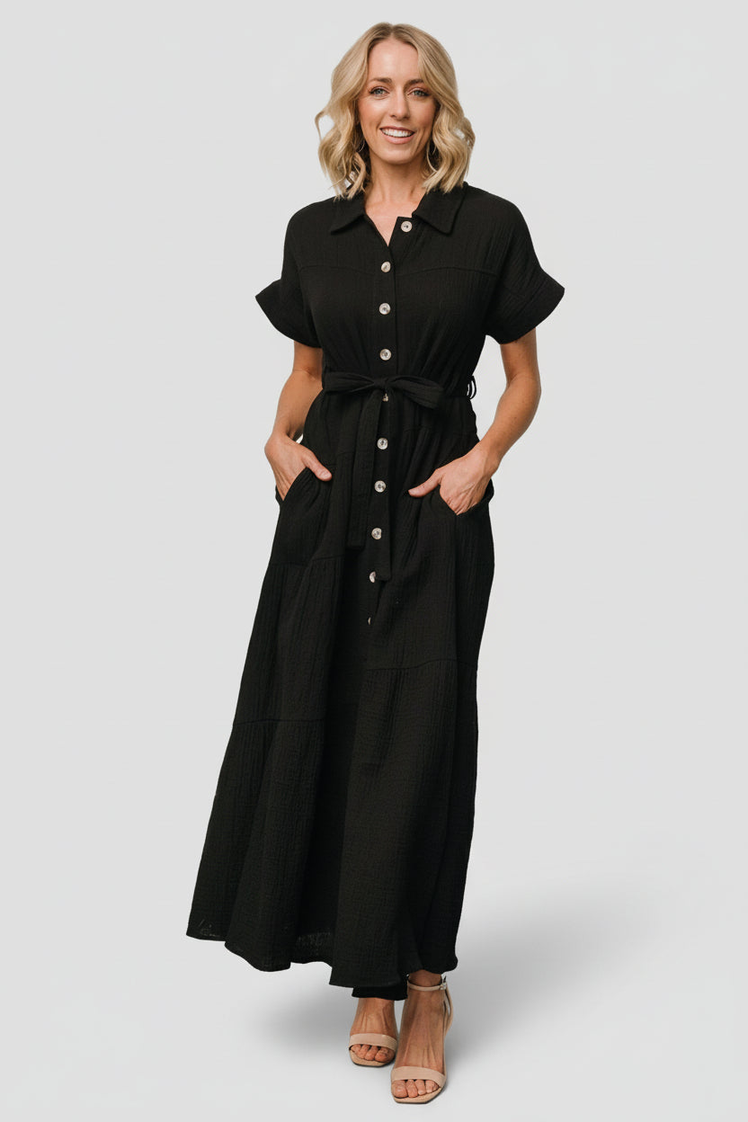 Aizey button-up maxi dress in black, front view on model showing collared bodice, functional buttons and self-tie waist sash for styling.
