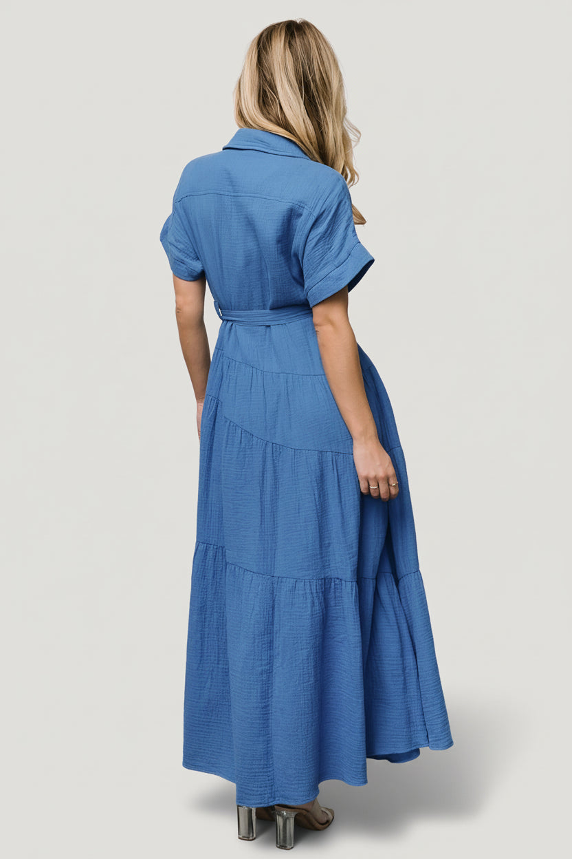 Styled flat-lay and detail shot of Aizey button-up maxi dress showing buttons, sash, and fabric texture in bright ocean blue.