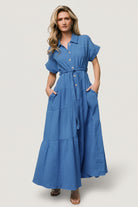 Model front view wearing Aizey blue button-up maxi dress in textured cotton, short dolman sleeves, button-front, self-tie sash and hidden pockets.