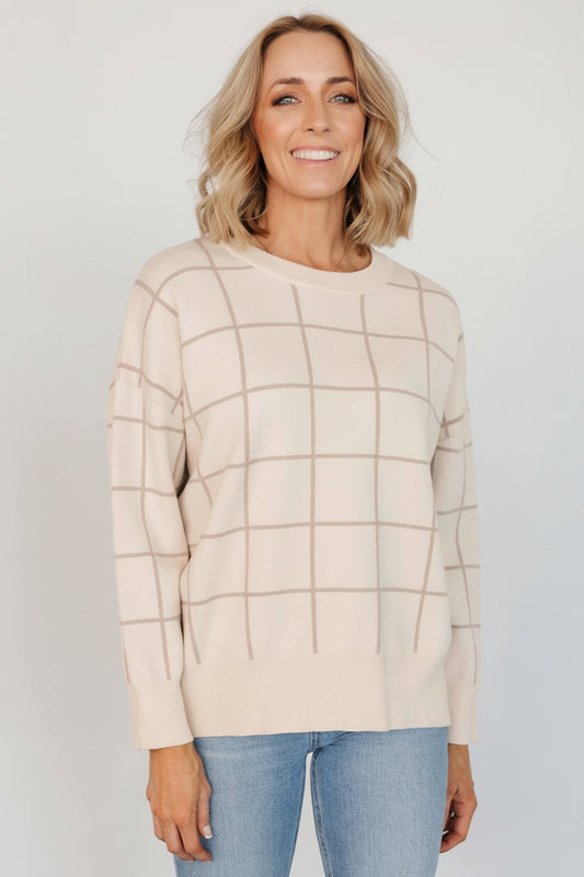 Front view of Alden knit sweater in oatmeal with taupe windowpane accents, showing ribbed neckline and long sleeves on model.