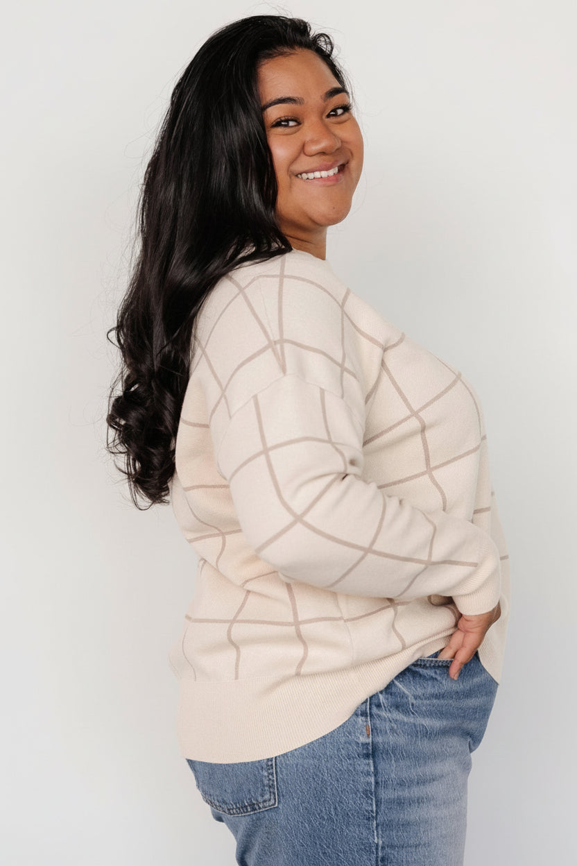 Back view of Alden knit sweater in oatmeal, revealing relaxed hemline, ribbed finish, and overall knit texture.