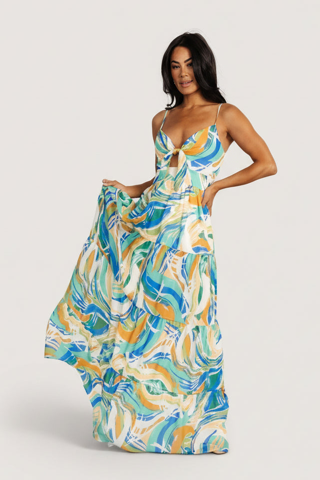 Back view showing smocked back and adjustable straps on the blue multi print Alexis chiffon maxi dress for a comfortable fit.