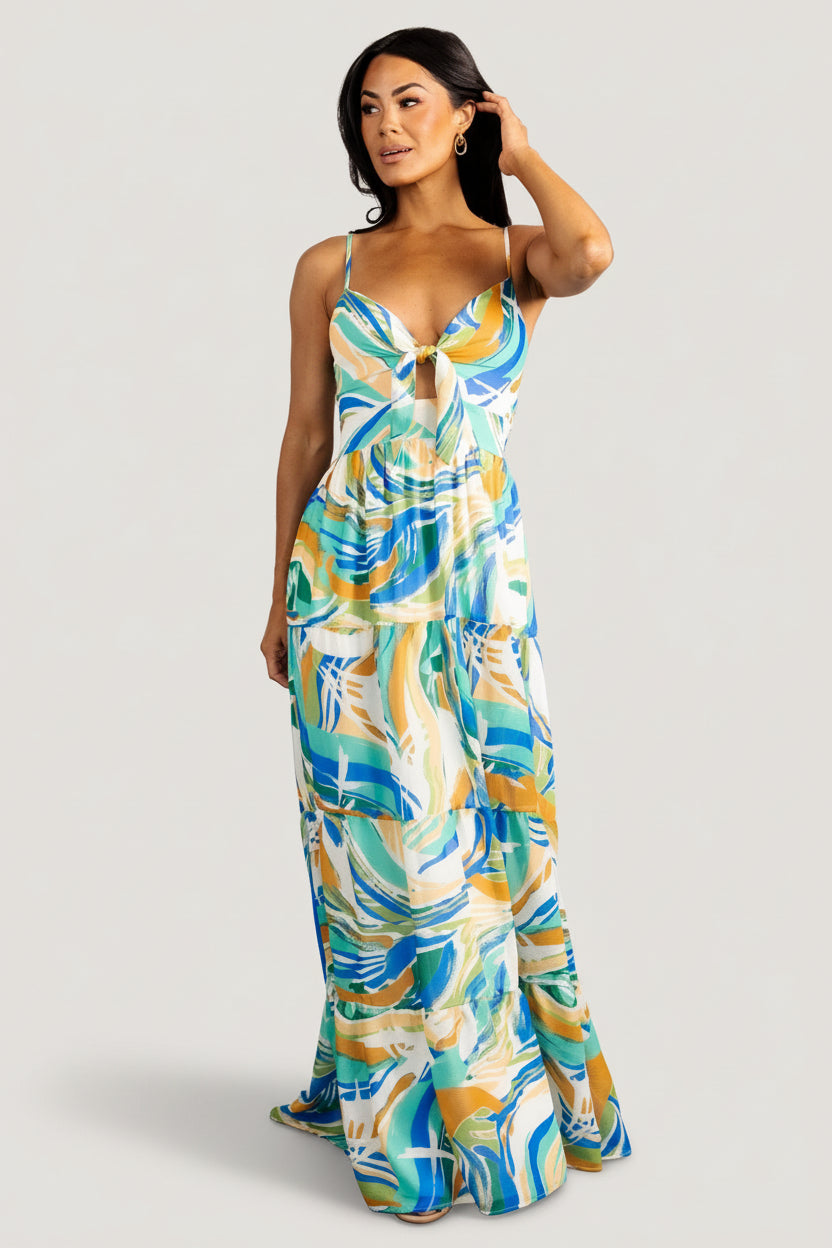 Front view of Alexis tiered chiffon maxi dress in blue multi print showing V-neckline, self-tie keyhole, and flowing tiered skirt.
