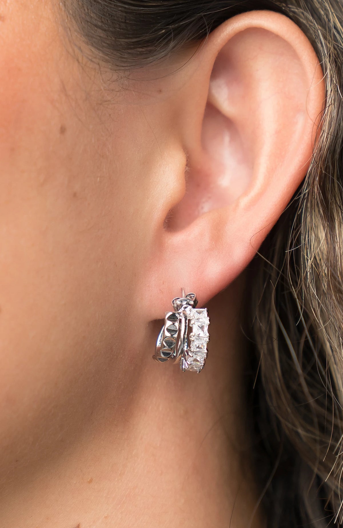 Ali Stacked Huggie Hoops in Silver with stacked design and cubic zirconia accents.