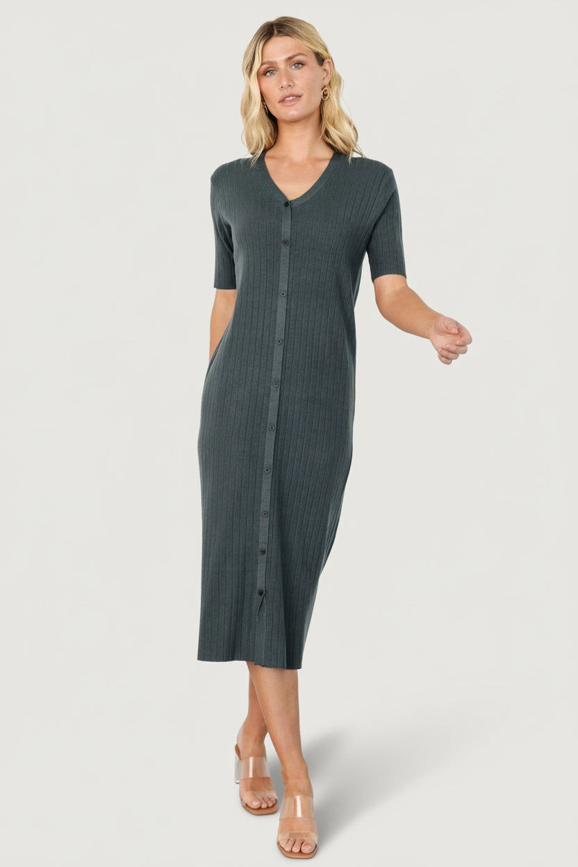Back view of the Alicia midi dress in dusty jade on model, showing hemline, knit texture, and comfortable, bump-friendly fit.