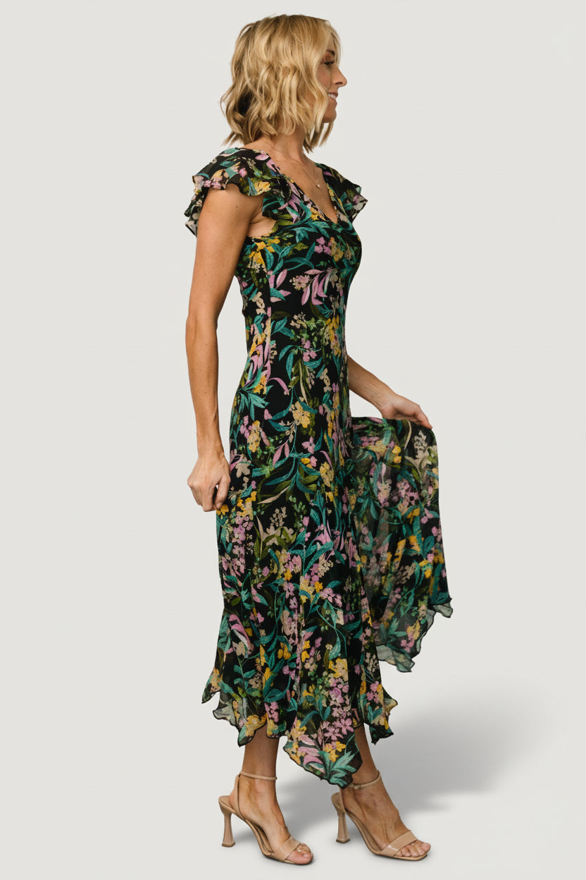 Side profile of the Alisa Maxi Dress displaying sleeve shape, relaxed fit, and the gentle flare at the skirt hemline.