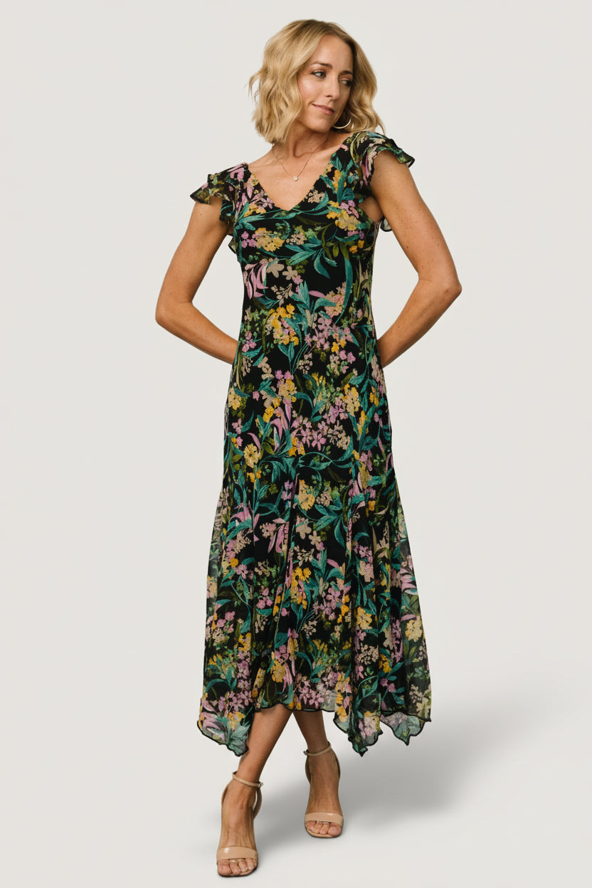 Full-length studio shot of the black floral maxi dress on model, styled with minimal accessories to show silhouette.