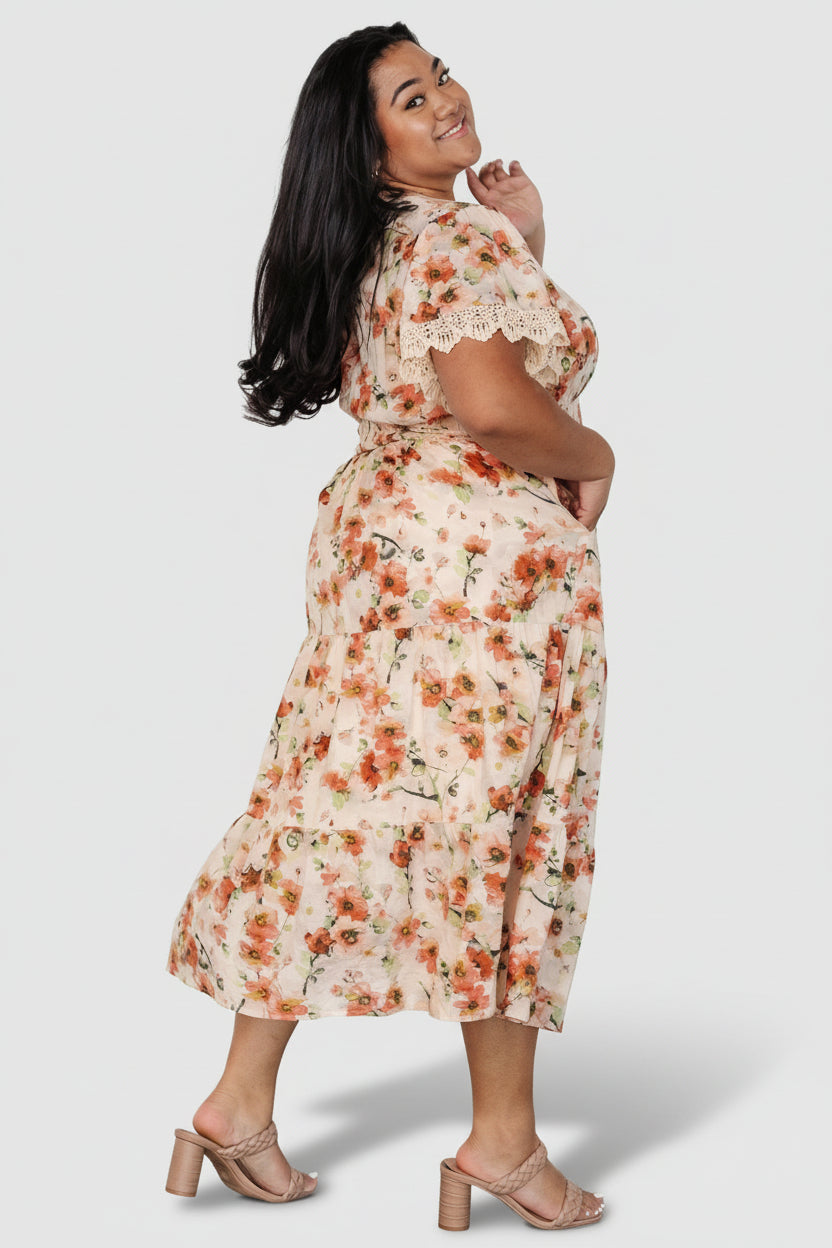 Close-up of the lace trim and sleeve hem on the Aliyah Midi Dress, showing stitching, texture, and delicate embellishment.