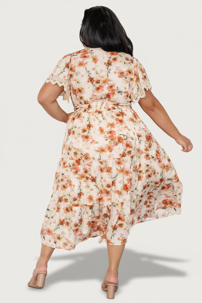 Model wearing the Aliyah Midi Dress, showing front styling with sandals and the flattering smocked waist and flowing skirt movement.