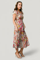 Detail image of the dress bodice focusing on functional buttons, V-neckline and floral print placement on lightweight rayon.