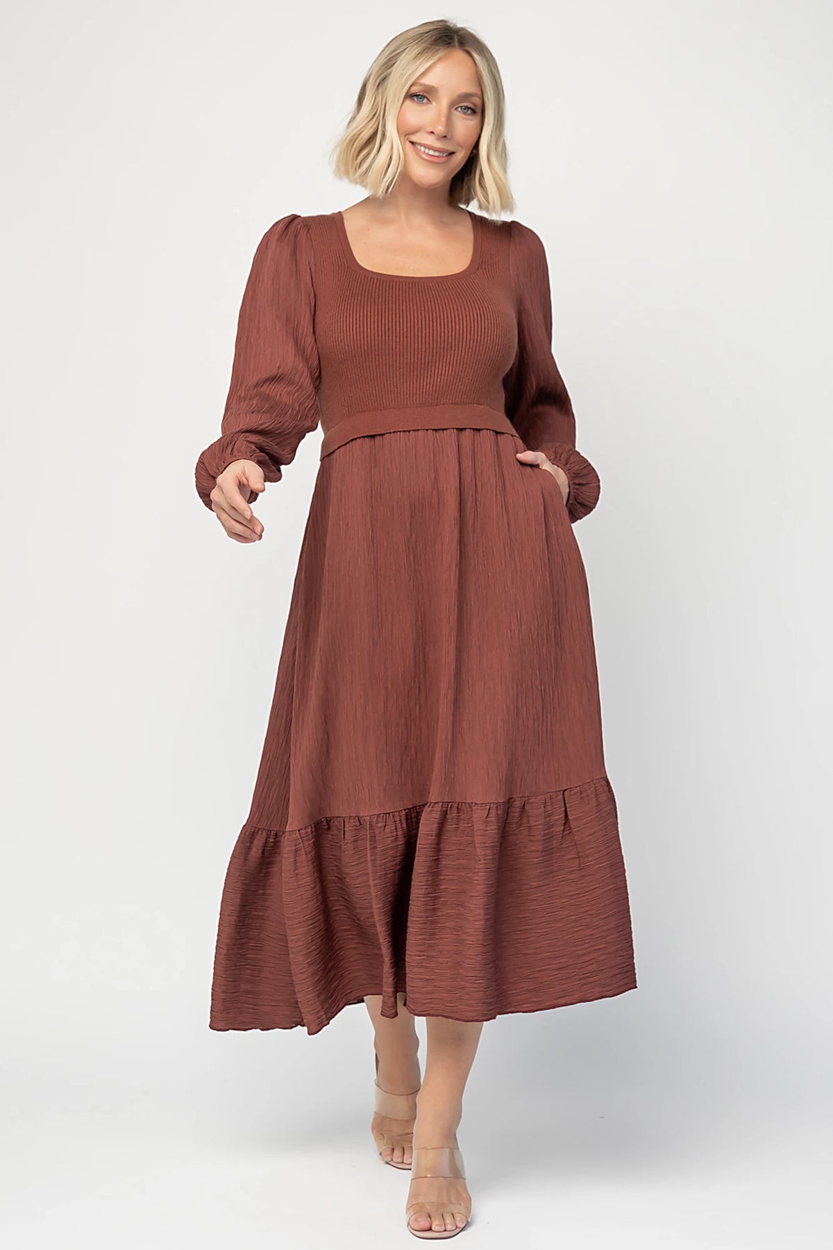 Alva Sweater Dress in Dusty Mahogany with ribbed knit bodice, square neckline, ruffle shoulders, long sleeves, and midi skirt.