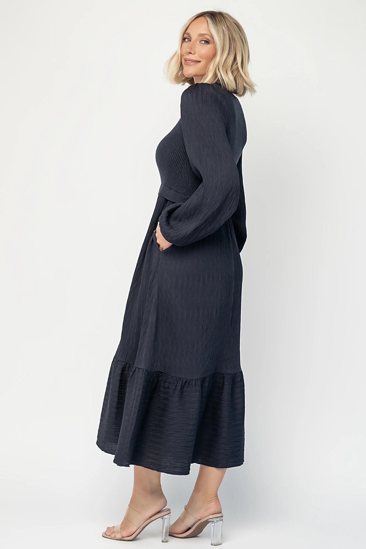 Alva Sweater Dress in Dusty Navy with ribbed knit bodice, square neckline, ruffle shoulders, long sleeves, and midi skirt.