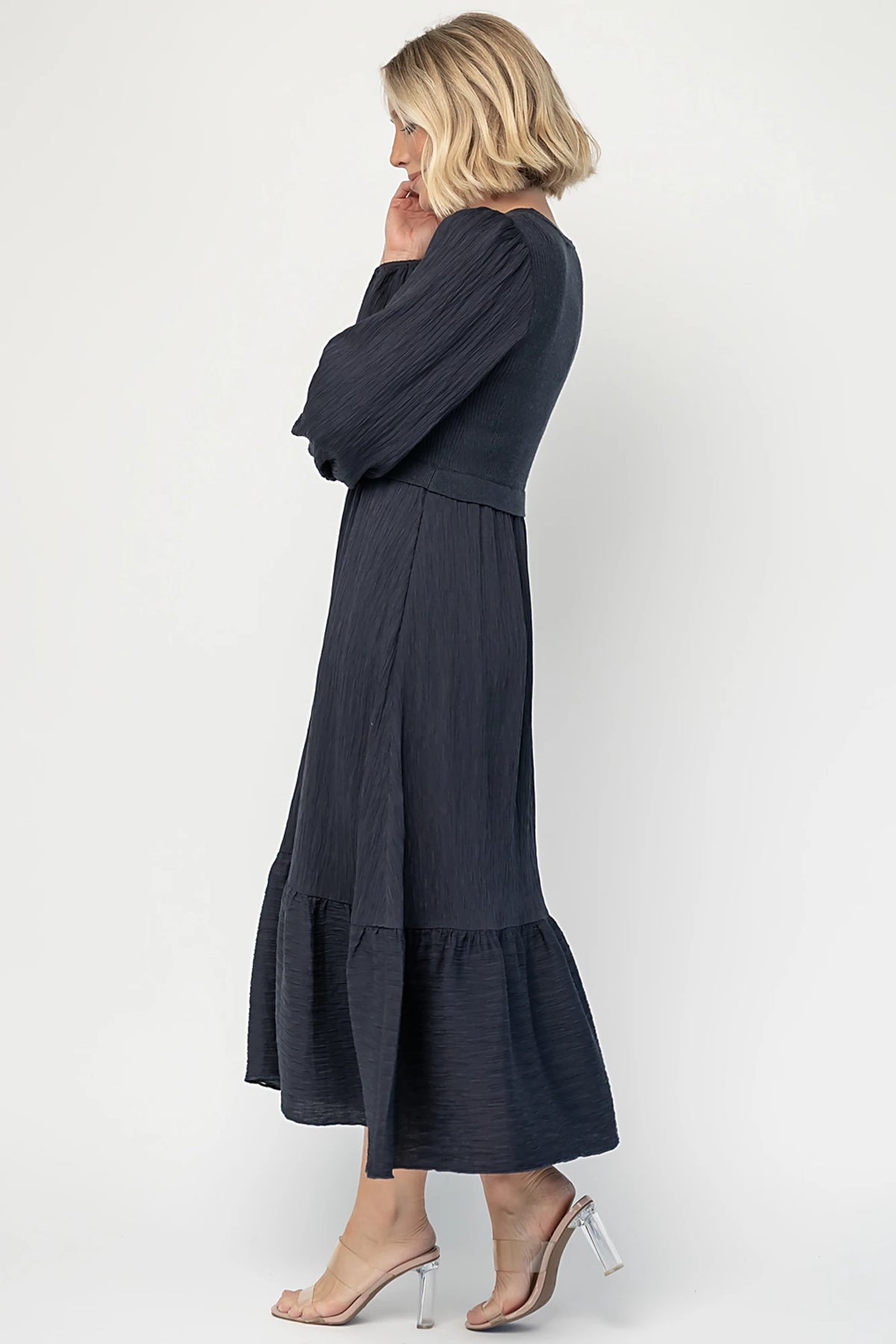 Alva Sweater Dress in Dusty Navy with ribbed knit bodice, square neckline, ruffle shoulders, long sleeves, and midi skirt.