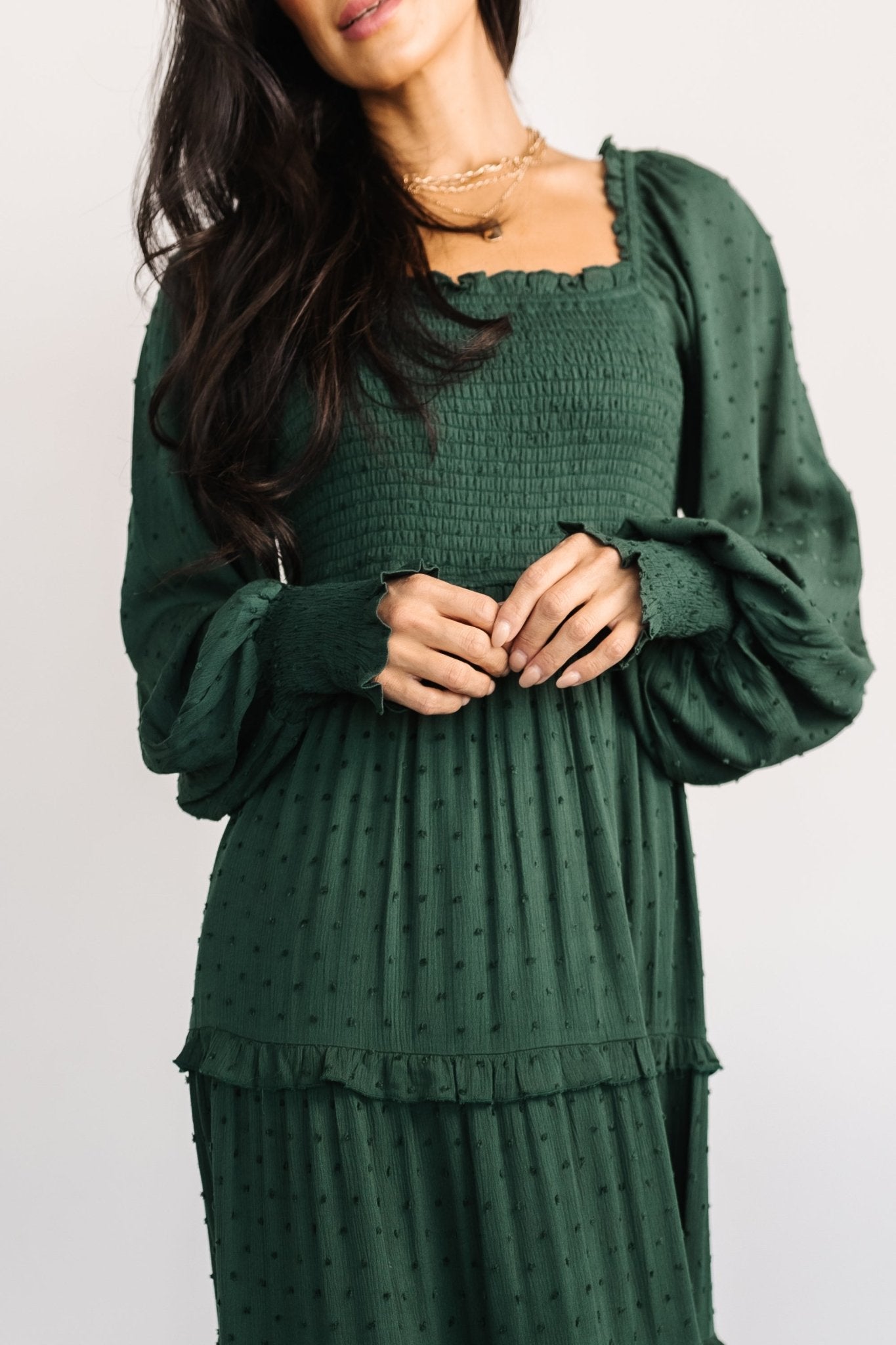 Full-length studio shot of the evergreen maxi dress on model, showing overall silhouette, skirt fullness, and maxi length.