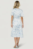 Detail image of the self-tie waist and wrap closure on the Amelie Wrap Midi Dress in blue floral print.