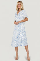 Studio image of Amelie Wrap Midi Dress on mannequin, highlighting true wrap design and fitted, lined bodice.