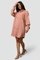 Close-up detail of the shirt dress fabric and buttons, showing the cotton-blend texture, functional button placket, and neat collar construction.