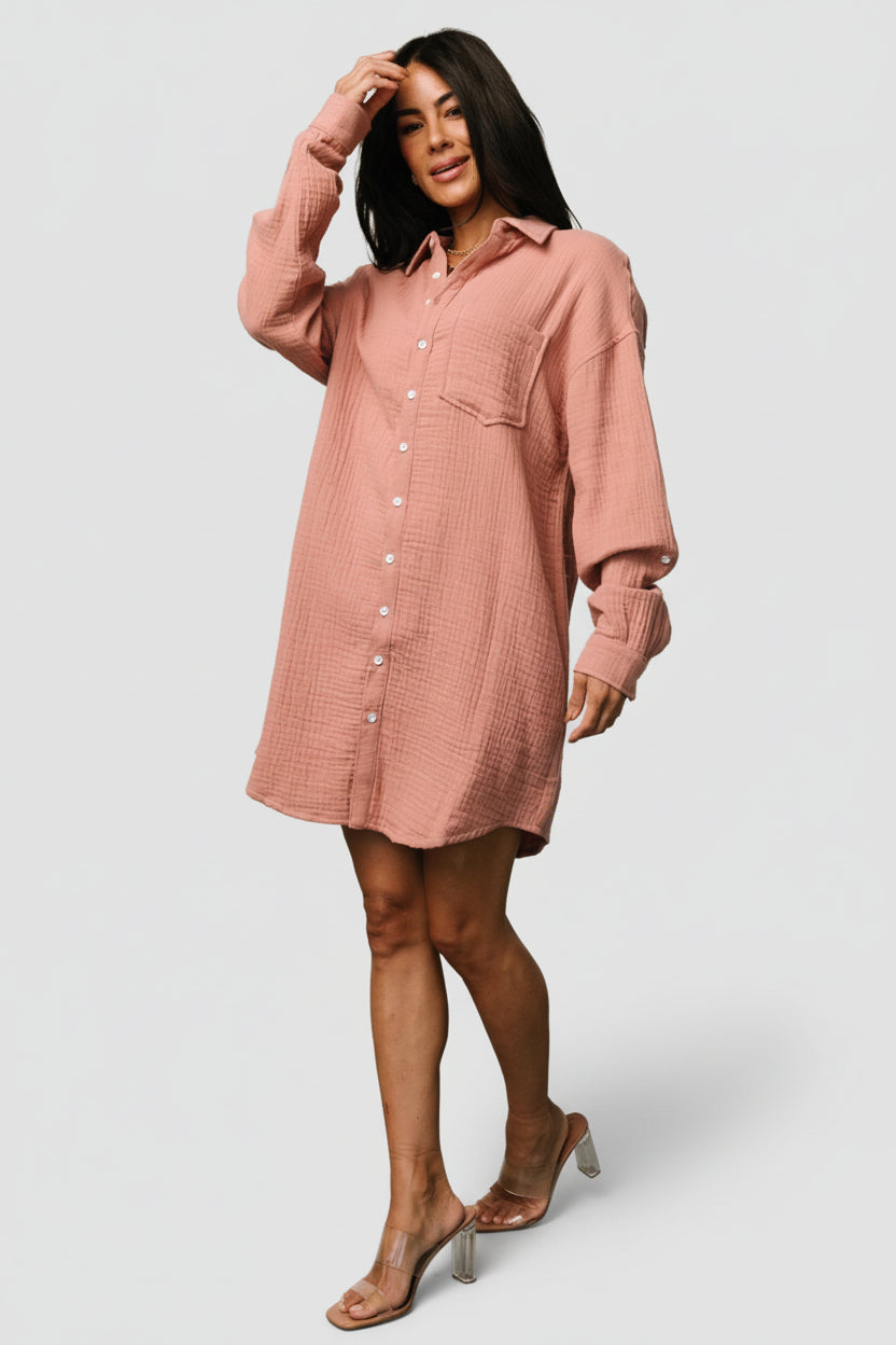 Close-up detail of the shirt dress fabric and buttons, showing the cotton-blend texture, functional button placket, and neat collar construction.