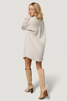 Styled look of light sage button shirt dress paired with boots and accessories, demonstrating day-to-night versatility.