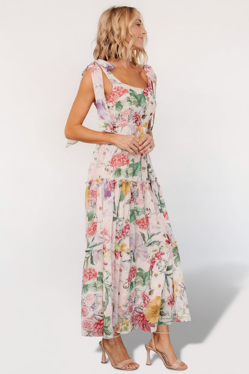Close-up of paneled front bodice and delicate multicolored floral print on the chiffon overlay of the maxi dress.
