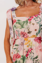 Back view highlighting the smocked back panel and adjustable straps on the blush multi floral maxi dress for a secure fit.