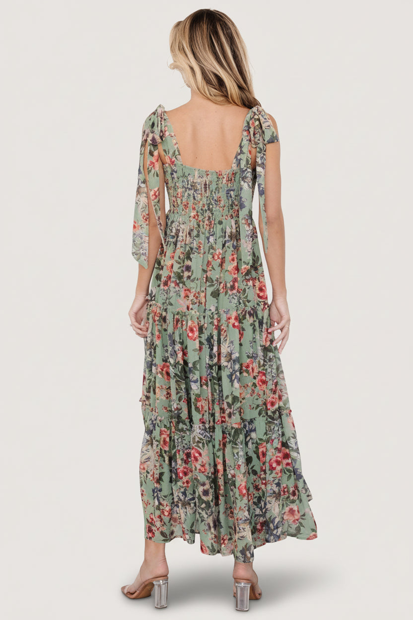 Side view of Anita Maxi Dress in green multi floral highlighting the three-tier ruffled maxi skirt and soft drape of chiffon overlay.