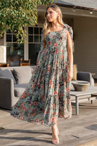 Close-up of Anita Maxi Dress bodice detailing: square neckline, paneled front, smocked back, and delicate chiffon fabric texture in green floral print.