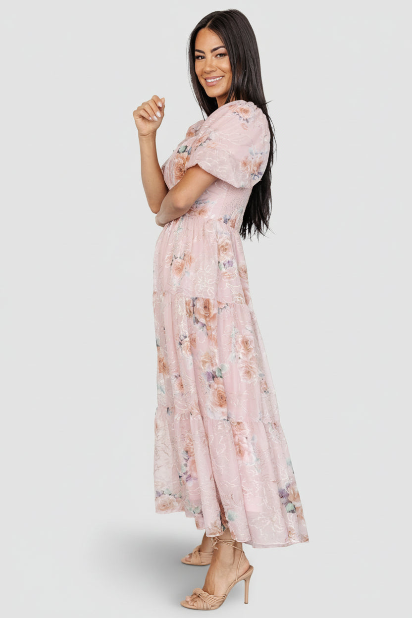 Side-angle of the blush floral tulle dress revealing three-tier midi skirt, hidden side pocket, and flowy silhouette.