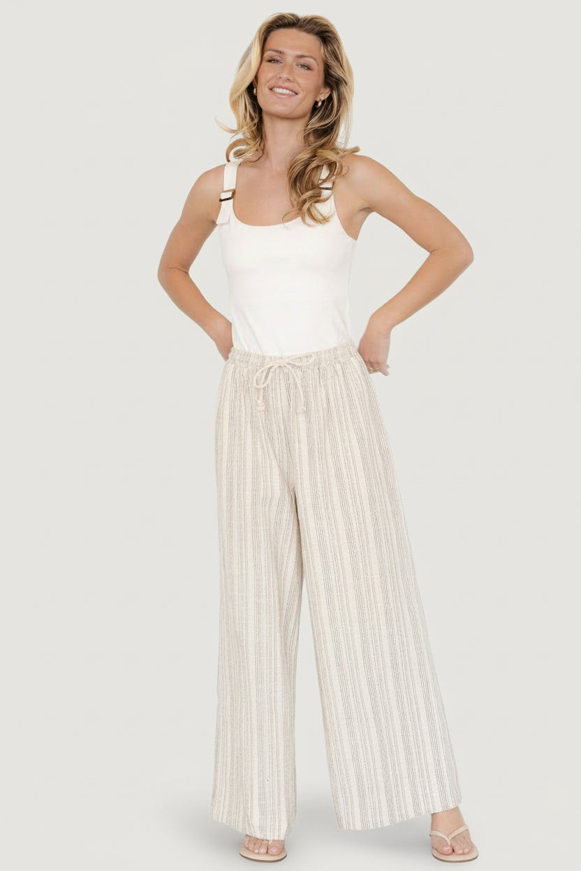 Model wearing Antale wide-leg pants in natural multi-stripe, showing relaxed fit and how the pant falls from the waist.