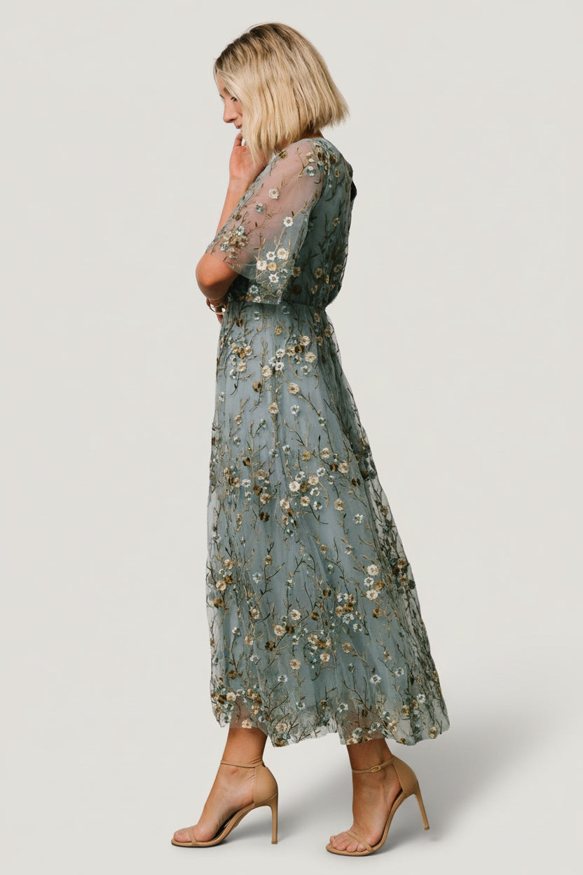 Detail of short sheer tulle sleeve and embroidery, highlighting delicate stitch work and the contrast between overlay and lining.