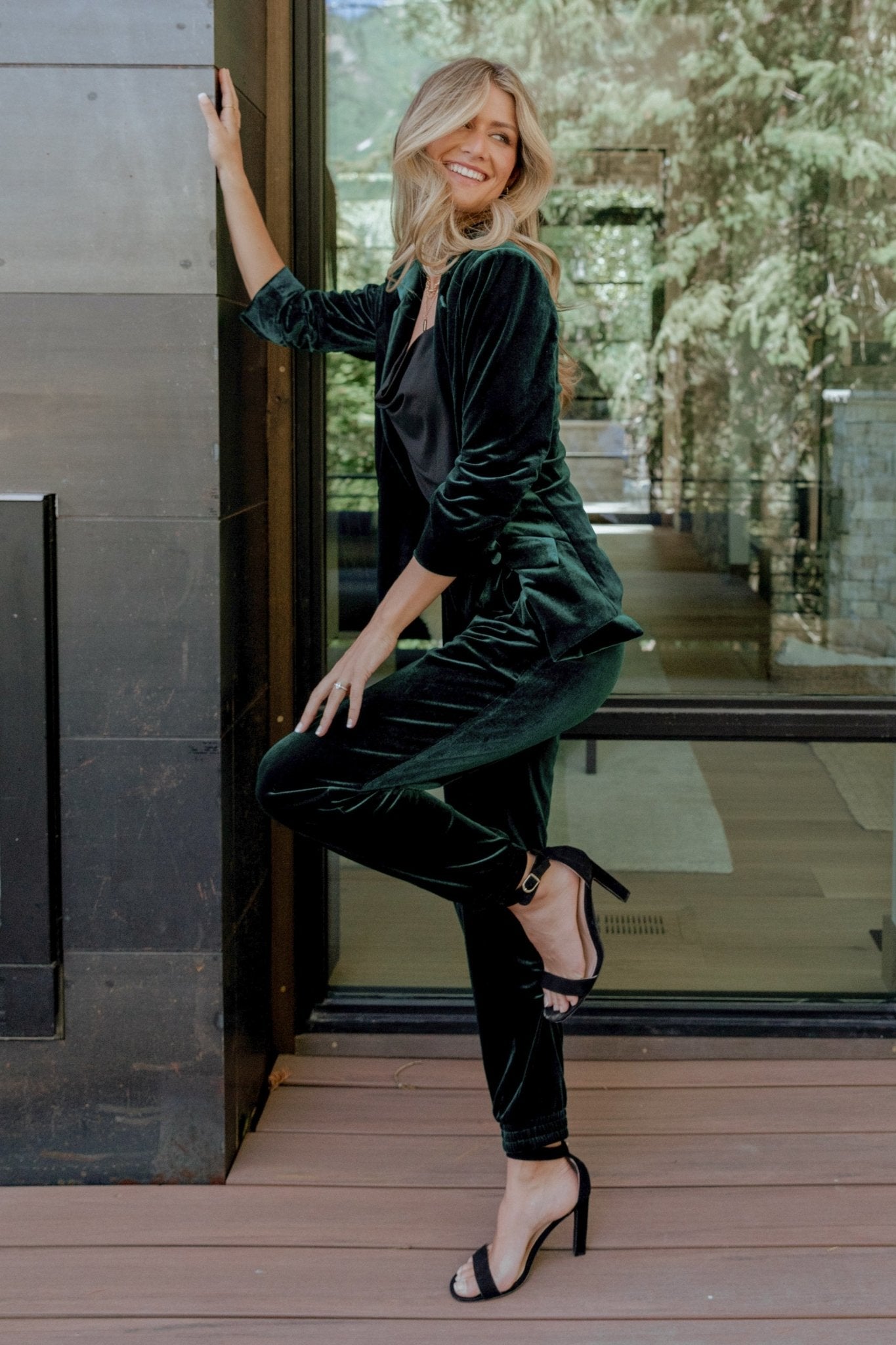 Detail shot of elastic waistband and upper hip on dark green Archie velvet jogger pants showing stretch and finish of fabric.