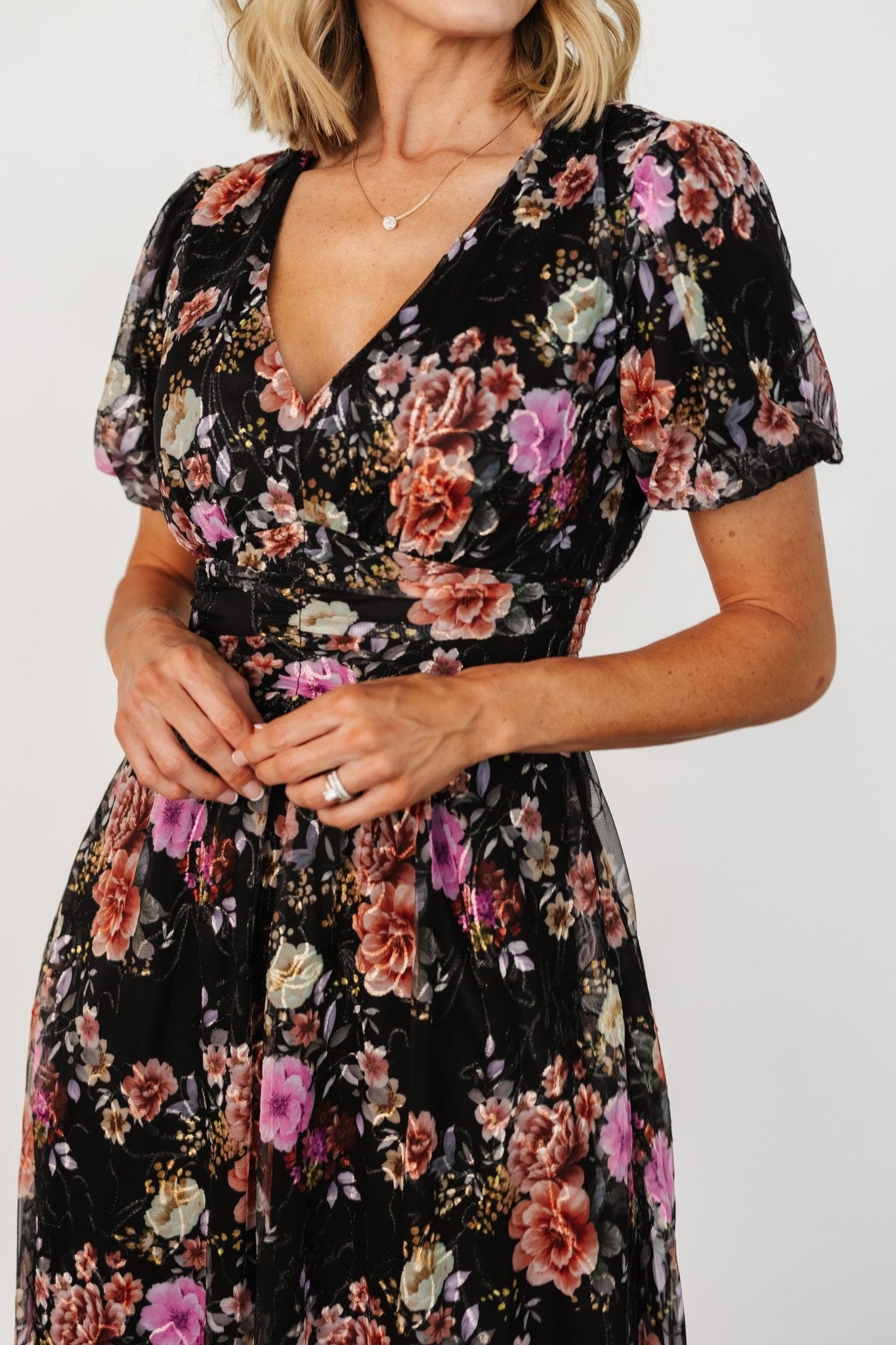 Full-length studio shot of Ardley Maxi Dress in black multi floral on model, showing silhouette, pockets, and ankle-skimming hem.
