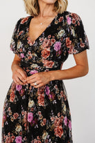 Full-length studio shot of Ardley Maxi Dress in black multi floral on model, showing silhouette, pockets, and ankle-skimming hem.