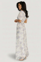 Close-up of cream and slate-blue floral print with subtle gold and cream embroidered thread for textured detailing.