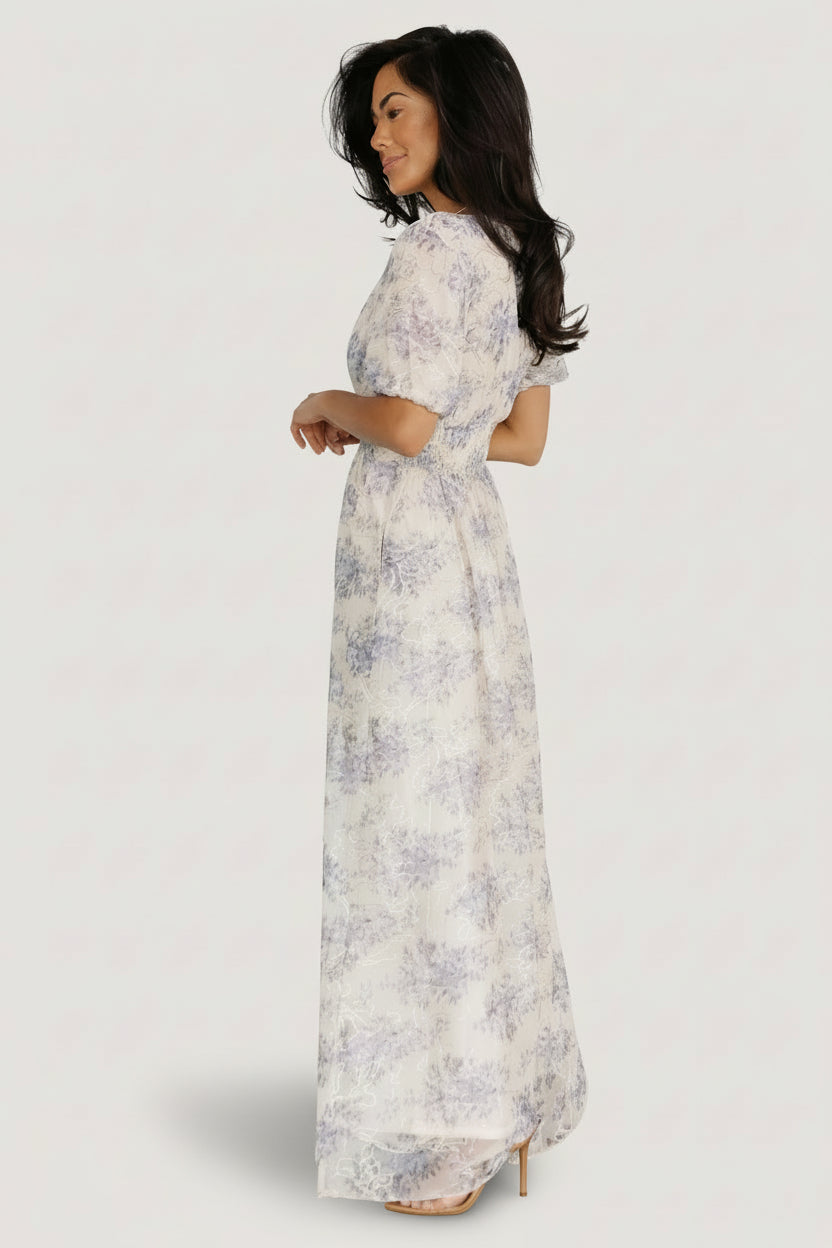 Close-up of cream and slate-blue floral print with subtle gold and cream embroidered thread for textured detailing.
