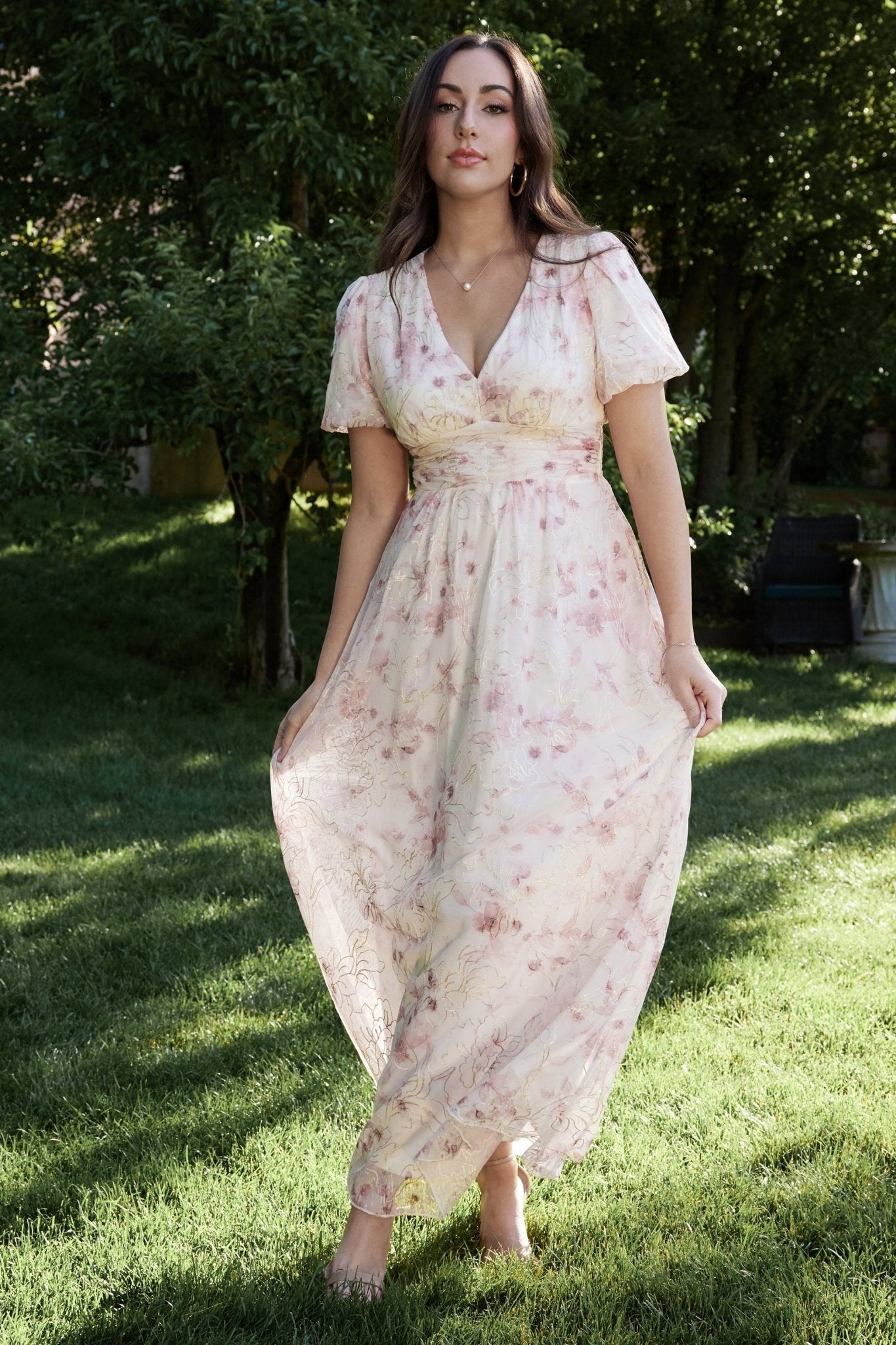 Styled shot of Ardley Maxi Dress in mauve floral paired with neutral heels, showing overall proportion, sleeve detail, and embroidered shimmer at the fabric surface.