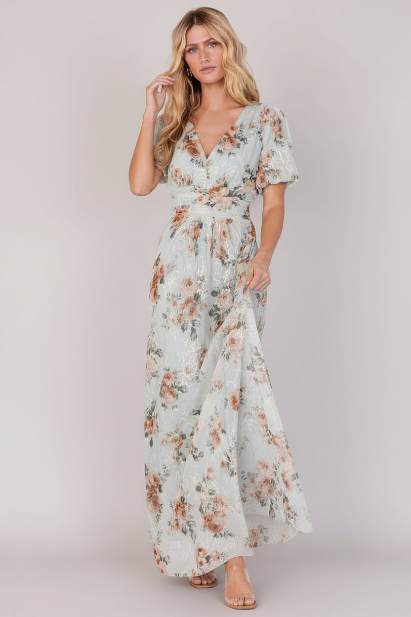 Front view of sage floral maxi dress with V-neck, short puff sleeves, gathered waist and embroidered gold-cream detailing.