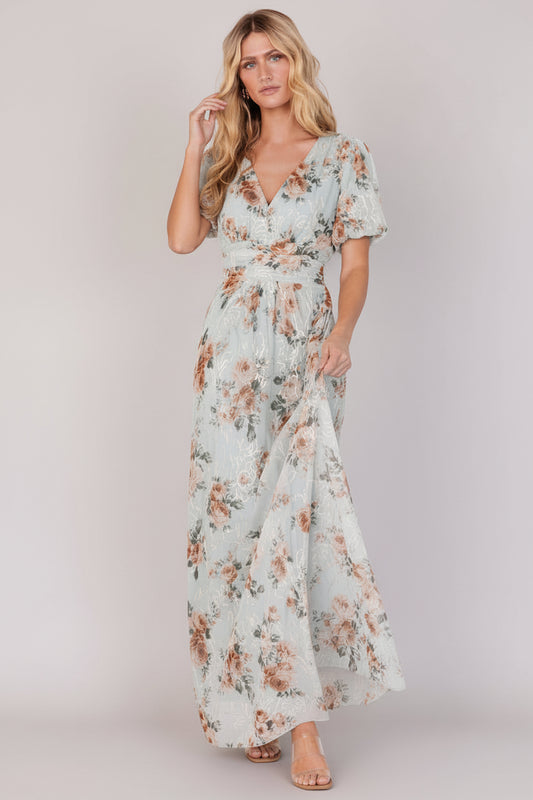 Front view of sage floral maxi dress with V-neck, short puff sleeves, gathered waist and embroidered gold-cream detailing.