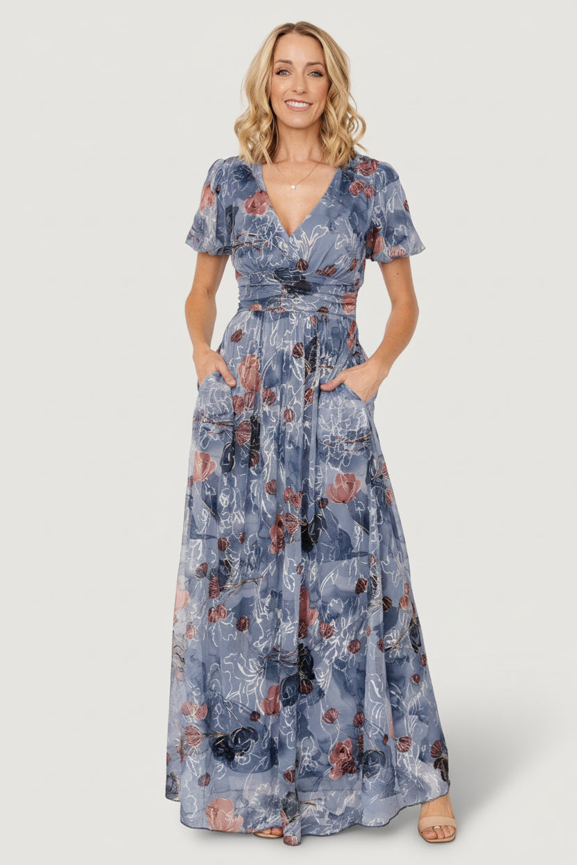 Model wearing Ardley Maxi Dress in Slate Print styled with minimal jewelry, demonstrating V-neckline, short puff sleeves, and flattering silhouette.