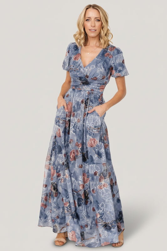 Front full-length view of Ardley Maxi Dress in Slate Print showing V-neck, short puff sleeves, embroidered floral tulle overlay and flowing maxi skirt.
