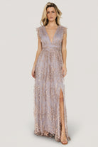 Three-quarter angle showing shimmer tulle overlay and rose-gold floral pattern with banded waist and flowing maxi skirt.